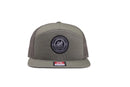Green trucker hat on white surface