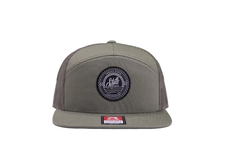 Green trucker hat on white surface