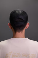 person wearing grey snapback trucker hat